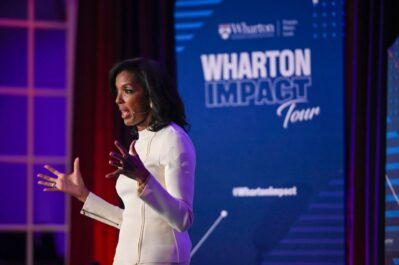 Photo of Dean Erika James speaking at Wharton Impact Tour