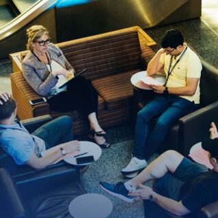 Wharton circles members having a meeting in a lounge area