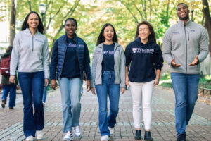 Picture of five Wharton Alumni Fellow students walking down Locust Walk