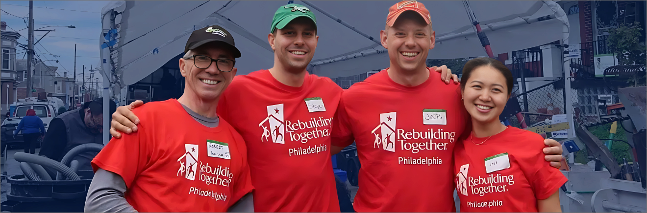 Four Volunteers in t-shirts that read Rebuilding Together Philadelphia