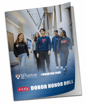 A group of students in a university hallway wearing Penn clothing, featured on the cover of the 2025 Wharton Donor Honor Roll booklet.