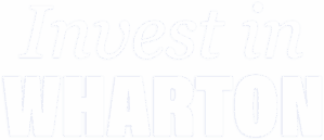 The image contains the phrase "Invest in WHARTON" in blue text with "WHARTON" highlighted in a bold, strong typeface.