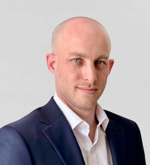 Ziv Barak wearing a blazer and smiling