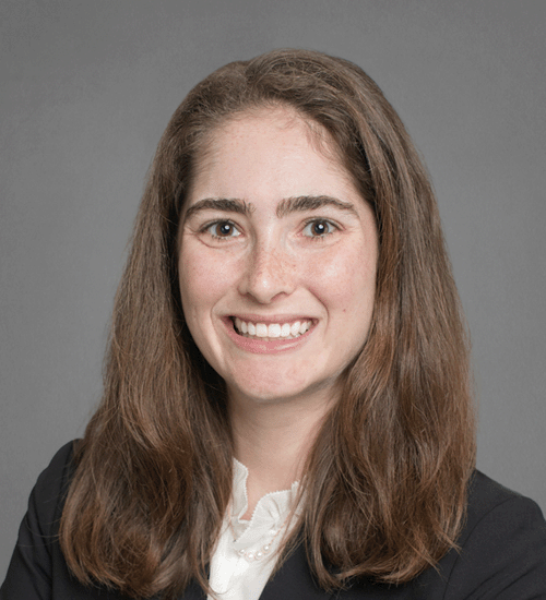 Claire Mendelson with long brown hair, and smiling