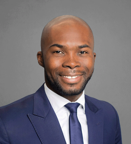 Dabila Ouattara wearing a blue blazer and tie, smiling
