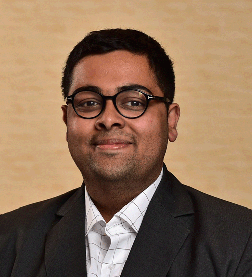 Sidharth Chopra wearing a blazer and smiling
