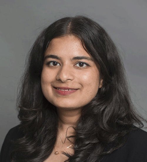 Sreelatha Challa with long hair and smiling